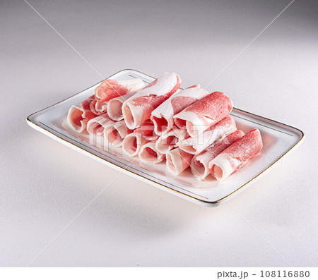 fresh and aesthethic bacon rolls on a white plate. View from above. Chinese cuisine, ingredient for hotpot 108116880