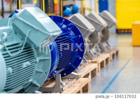 new electric motors different colors and sizes on pallets in the warehouse in factory 108117032