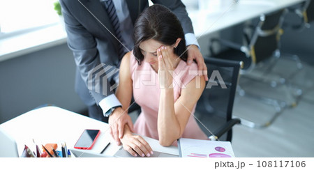 Businessman pestering female colleague in the workplace. Businessman pestering female colleague in the workplace. 108117106