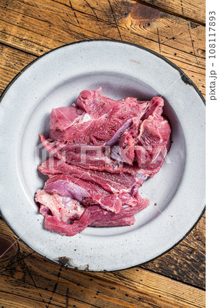 Pieces of raw turkey thigh, Poultry fresh meat. Wooden background. Top view Pieces of raw turkey thigh, Poultry fresh meat. Wooden background. Top view 108117893