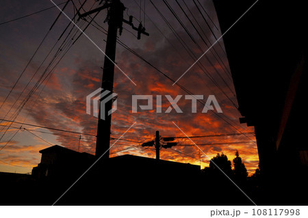 電線のシルエットがノスタルジックな田舎の夕焼け 電線のシルエットがノスタルジックな田舎の夕焼け 108117998