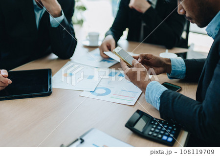 Asian business advisor meeting to analyze and discuss the situation on the financial report in the meeting room.Investment Consultant, Financial , teamwork ,brainstorming ,startup and accounting. Asian business advisor meeting to analyze and discuss the situation on the financial report in the meeting room.Investment Consultant, Financial , teamwork ,brainstorming ,startup and accounting. 108119709