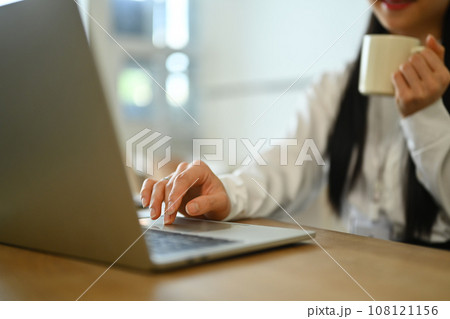 Female investment advisor chatting with client online, communicating on internet via laptop computer 108121156
