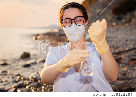 Woman ecologist makes examination on breakdown of water from ocean. Concept of purification of planet's water resources 108122284