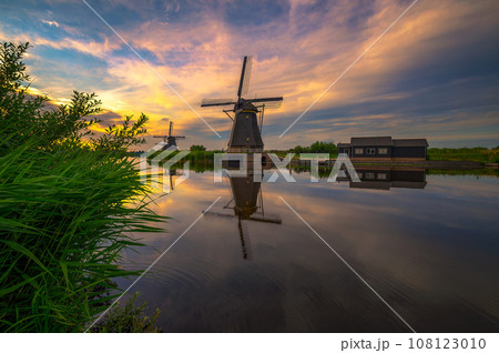 Sunset above old dutch windmill in Kinderdijk, Netherlands Sunset above old dutch windmill in Kinderdijk, Netherlands 108123010