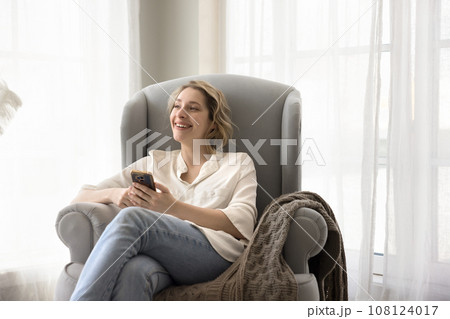 Attractive woman use phone thinking about new purchase 108124017