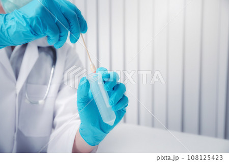 Doctor or medical staff is collecting secretions from patient for examination in the lab. Pandemic Coronavirus, COVID-19. Doctor or medical staff is collecting secretions from patient for examination in the lab. Pandemic Coronavirus, COVID-19. 108125423