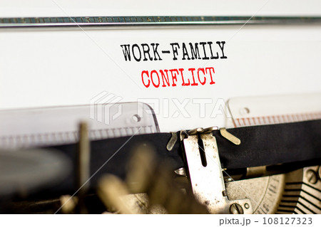 Work-family conflict symbol. Concept words Work-family conflict on white paper typed on old retro typewriter on beautiful white background. Business work-family conflict concept. Copy space. Work-family conflict symbol. Concept words Work-family conflict on white paper typed on old retro typewriter on beautiful white background. Business work-family conflict concept. Copy space. 108127323