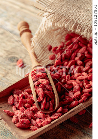 Dried goji berries on a wooden table. 108127801