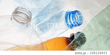 Many transparent bottles color plastic PET recycling waste. Empty plastic bottles background. Pile of empty bottle recycling plastic material recyclable waste sorting. Recyclable trash recycle garbage 108128453