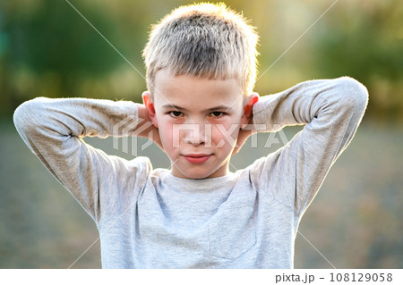 Portrait of a child boy outdoors on a warm sunny summer day. Portrait of a child boy outdoors on a warm sunny summer day. 108129058