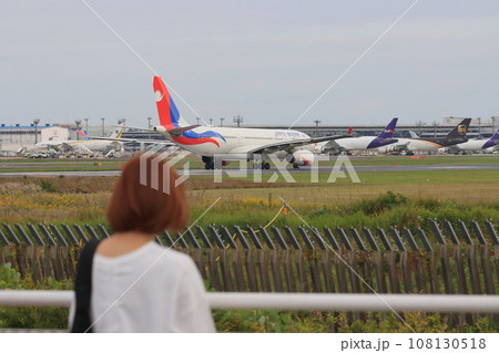 離陸する旅客機を見送る女性 カップル 離陸する旅客機を見送る女性 カップル 108130518