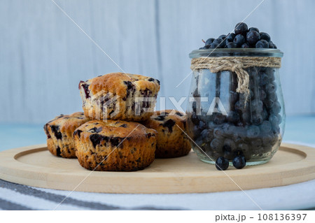 Homemade baked blueberry muffins with fresh harvested blackberries in glass jar. Tasty pastry sweet cupcake dessert. Berry pie cupcakes with organic berries. Gluten free healthcare recipe from 108136397