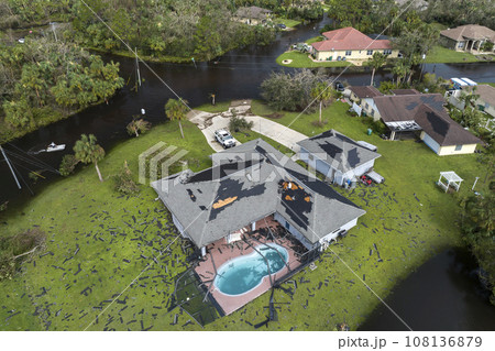 Consequences of natural disaster. Heavy flood with high water surrounding residential houses after hurricane Ian rainfall in Florida residential area 108136879