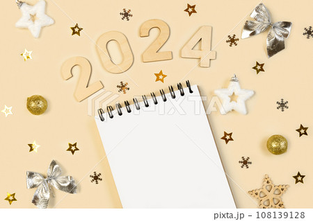 New Year Aims 2024. To Do List. Empty Notebook at the Desk with Holiday Decoration. Top view. Creating Plan, Resolution. New Life, Start Up, Beginning Concept. Business ideas. Goals, action, checklist 108139128