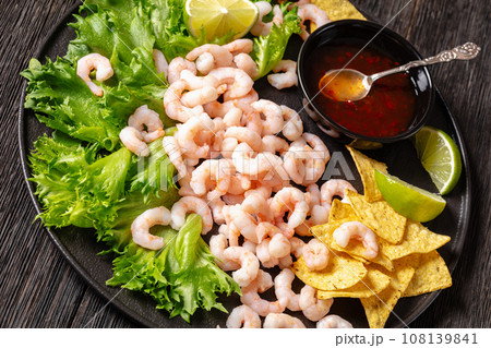 shrimps with lettuce, corn chips, chili sauce shrimps with lettuce, corn chips, chili sauce 108139841