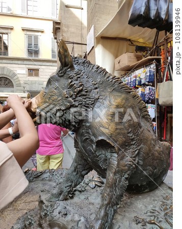 Detail of Hand touching good luck copper pig statue in Florence 108139946
