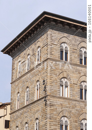 Colorful historic streets of Florence, Italy. Narrow old street, building's facade, brick walls. Colorful historic streets of Florence, Italy. Narrow old street, building's facade, brick walls. 108140001