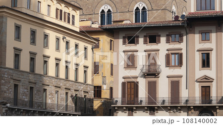Colorful historic streets of Florence, Italy. Narrow old street, building's facade, brick walls. Colorful historic streets of Florence, Italy. Narrow old street, building's facade, brick walls. 108140002