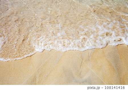 Soft sea waves on sunny sandy beach top view 108141416