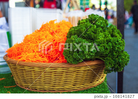 Green parsley and chopped carrots in basket, selective focus 108141827