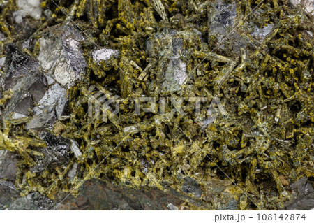 Macro mineral Epidote stone on a white background Macro mineral Epidote stone on a white background 108142874