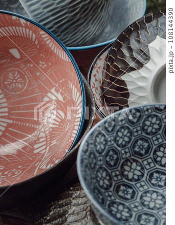 The stack of ceramics bowls in various shades. Details of ceramics bowls. The stack of ceramics bowls in various shades. Details of ceramics bowls. 108144390