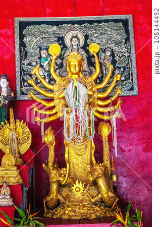 Old golden statue Guan Yin many-armed in temple. Guanyin from Buddhist bodhisattva Old golden statue Guan Yin many-armed in temple. Guanyin from Buddhist bodhisattva 108144452