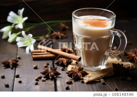 Spiced tea with milk on the rustic wooden table. 108148590