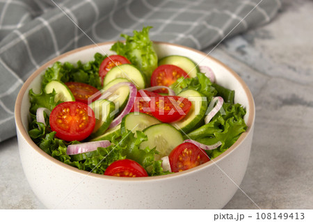 Vegetable salad with cucumber, tomato, onion, green salad and linseed seeds. Close up photo of healthy food 108149413