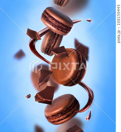 French strawberry macarons with berries on the air. Concept of levitation. Blue background. 108150443