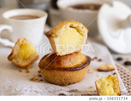Pasticciotto leccese pastry filled with egg custard cream on a napkin close up Pasticciotto leccese pastry filled with egg custard cream on a napkin close up 108151734