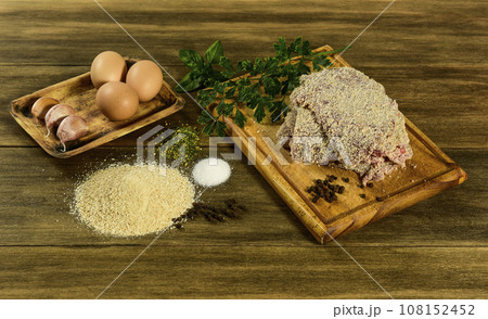 Veal milanese presented on the table with ingredients Veal milanese presented on the table with ingredients 108152452