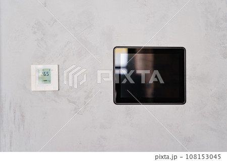 Video intercom screen and electronic thermometer on grey wall. Video intercom screen and electronic thermometer on grey wall. 108153045
