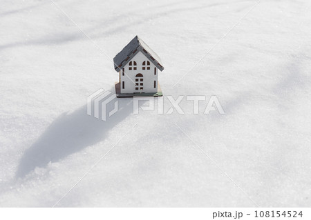model of house is standing in snow, mock-up, sale of real estate, rent of an apartment or house. 108154524