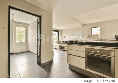 a kitchen area with an oven and stove in the middle of the room that is open to the living space a kitchen area with an oven and stove in the middle of the room that is open to the living space 108155296