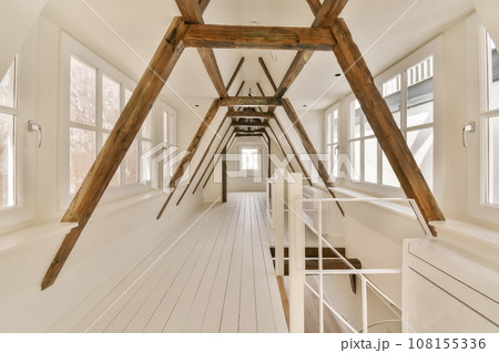 a room with white walls and wood beams on the ceiling, there is a ladder leading up to the loft a room with white walls and wood beams on the ceiling, there is a ladder leading up to the loft 108155336