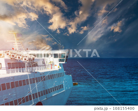 Floating cruise ship at sunset 108155400