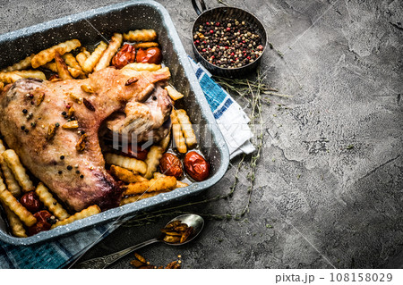 Turkey wing with french fries in baking tray top view Turkey wing with french fries in baking tray top view 108158029