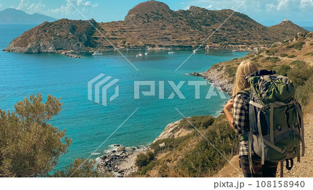 Girl is traveling in Turkey. View of lighthouse in ancient city of Knidos Girl is traveling in Turkey. View of lighthouse in ancient city of Knidos 108158940