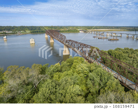 Chain of Rocks on the Mississippi RIver above St Louis with water towers, old historic bridge and the new bridge with construction work 108159471