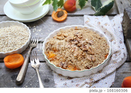 Apricot crumble from oatmeal, walnuts dressing for healthy breakfast Apricot crumble from oatmeal, walnuts dressing for healthy breakfast 108160306