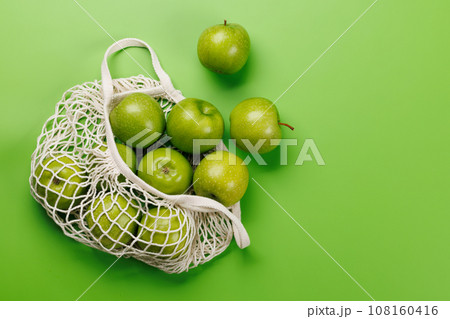 Mesh bag with fresh green apples Mesh bag with fresh green apples 108160416