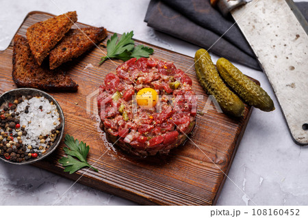 Savory beef tartare and brown bread toasts Savory beef tartare and brown bread toasts 108160452