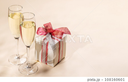 Two champagne glasses and gift box 108160601