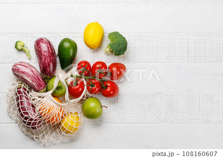 Mesh bag filled with a variety of vegetables 108160607