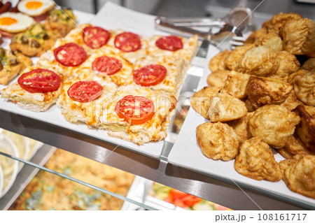 Various hot dishes . Glass Showcase in a buffet or self-service restaurant. 108161717