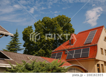 Solar photovoltaic panels on house roof. Modern country house with self-sustaining energy system. Suburb of Vienna, Austria. Idea harnessing clean and sustainable energy, saving money on electricity Solar photovoltaic panels on house roof. Modern country house with self-sustaining energy system. Suburb of Vienna, Austria. Idea harnessing clean and sustainable energy, saving money on electricity 108161935