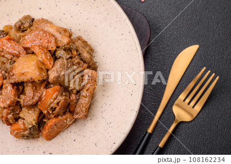 Delicious vegetable stew of potatoes, beef meat, mushrooms, carrots, salt, spices and herbs Delicious vegetable stew of potatoes, beef meat, mushrooms, carrots, salt, spices and herbs 108162234