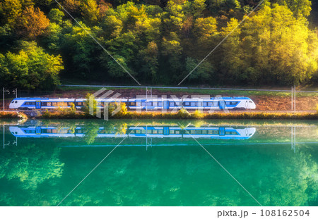 Beautiful blue modern high speed train and river in mountains 108162504